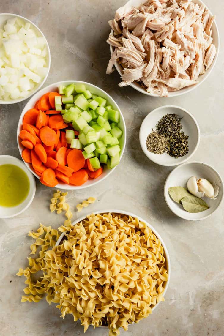 Ingredients for chicken noodle soup prepped on the counter.