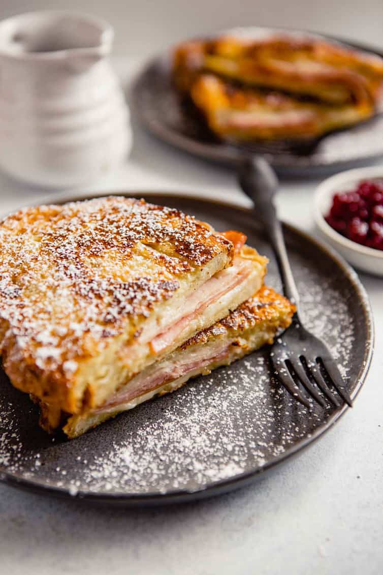 Monte Cristo sandwich on a plate with a fork.