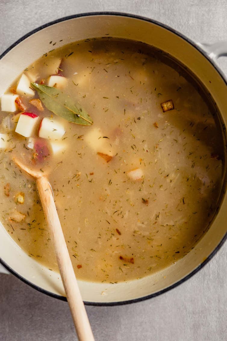 New England clam chowder after liquid and potatoes have been added.
