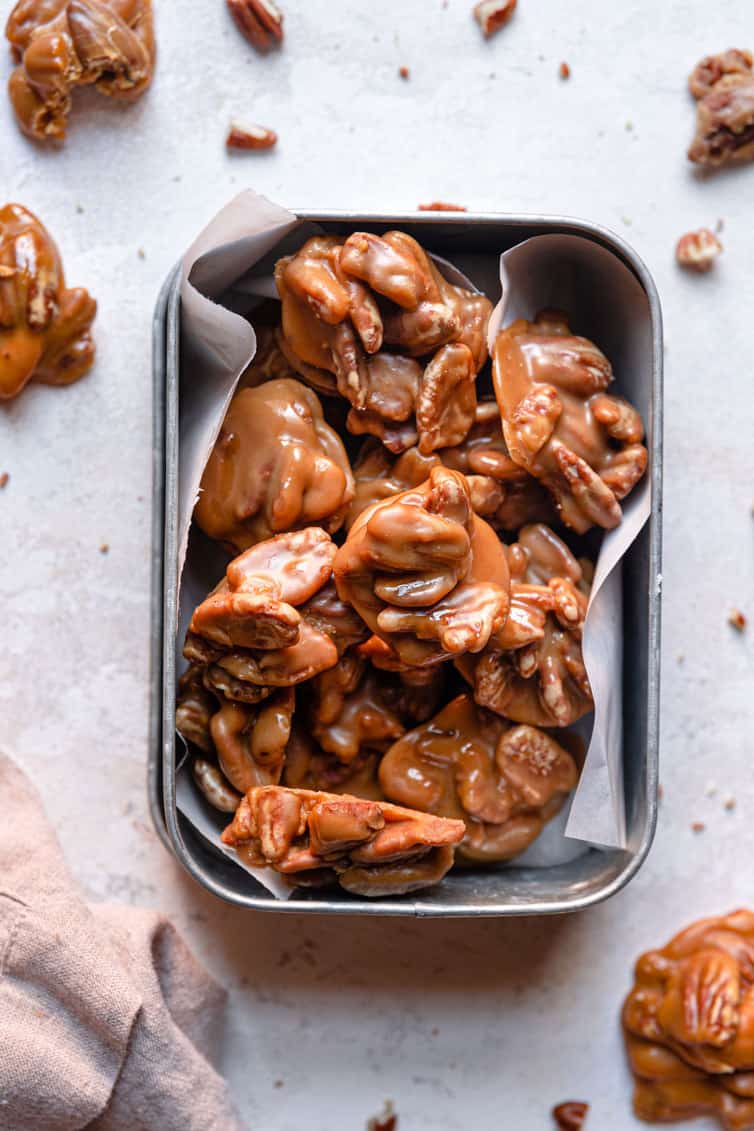 Pecan pralines packaged in a parchment-lined tin.