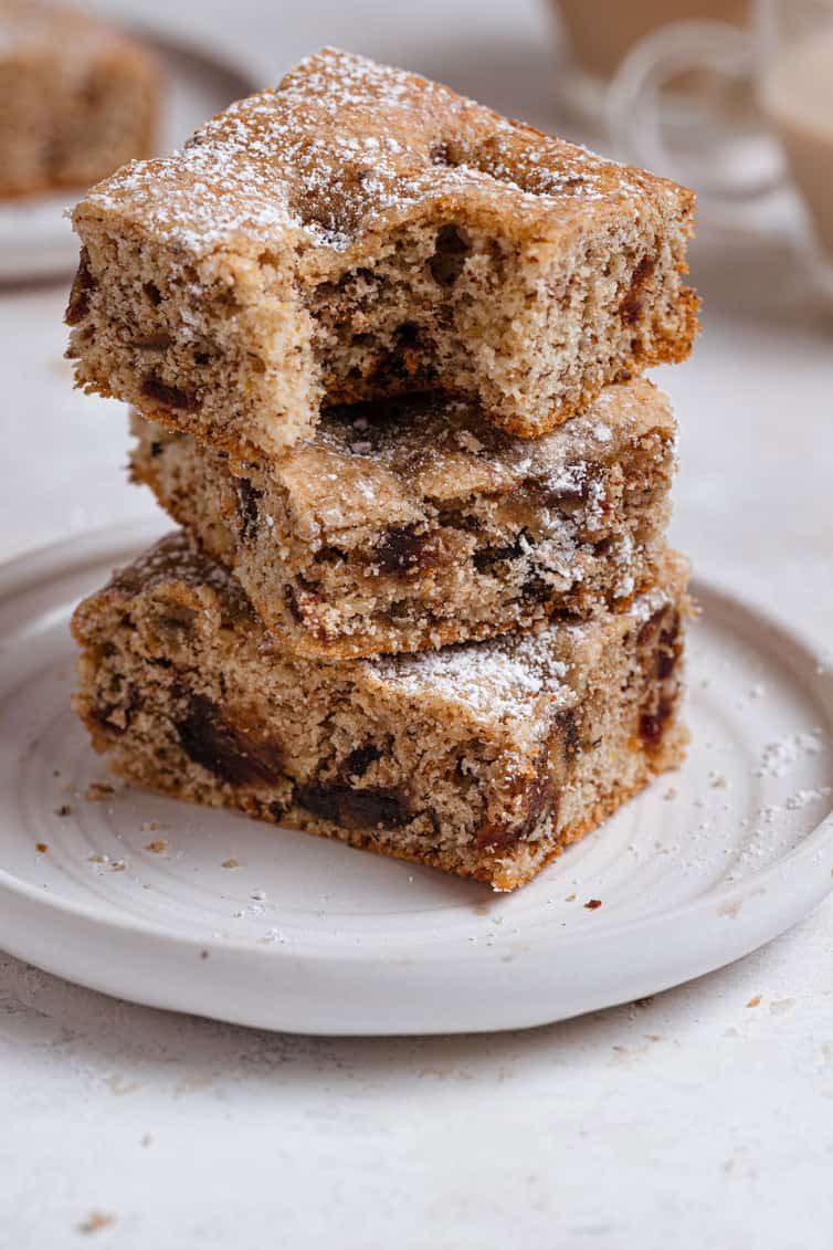 Stack of three date bars with a bite taken out of the top one.