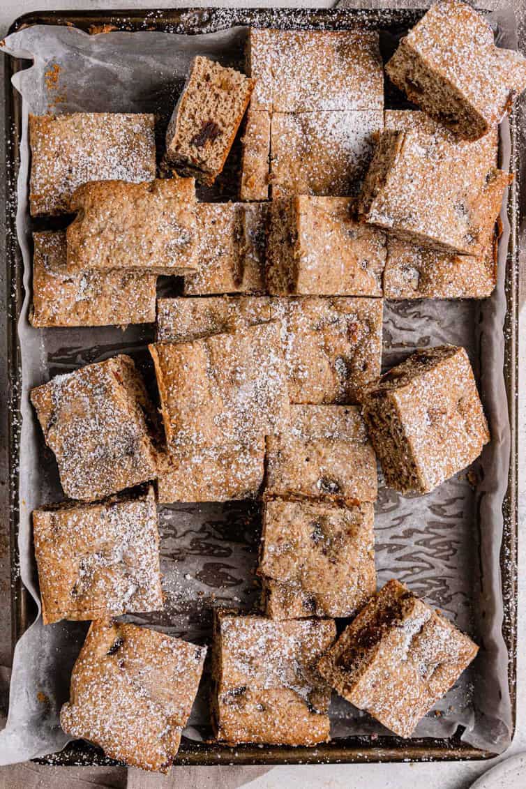 Date bars cut into squares on baking pan.