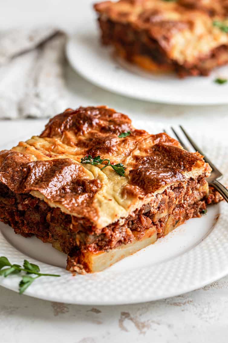 Slice of moussaka on a white plate.