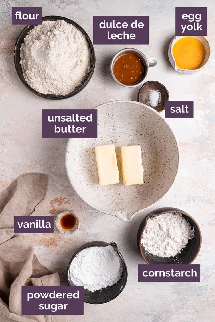 The ingredients for alfajores labeled on a white counter.