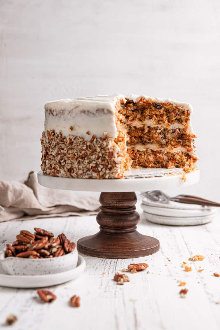 Carrot cake on a cake pedestal, showing the inside of the cake.