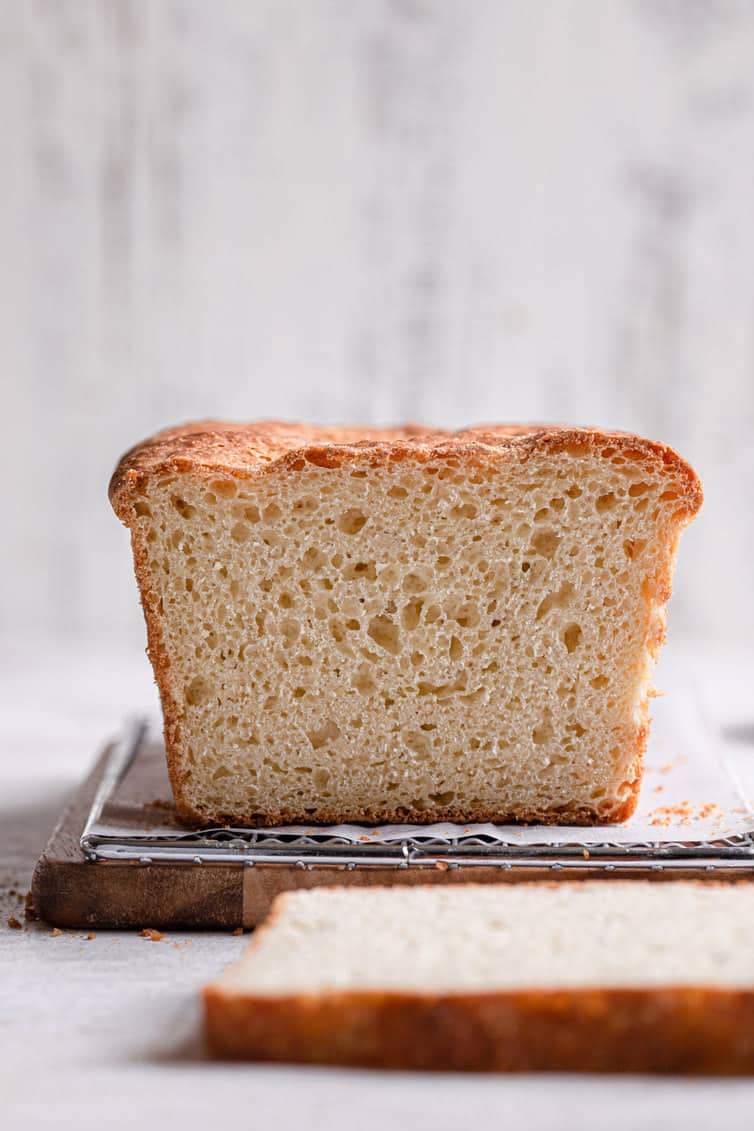 Sliced english muffin bread on a cutting board.