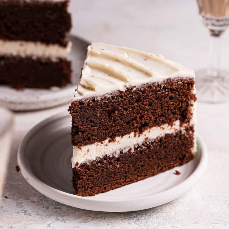 A slice of chocolate Guinness cake on a white plate.