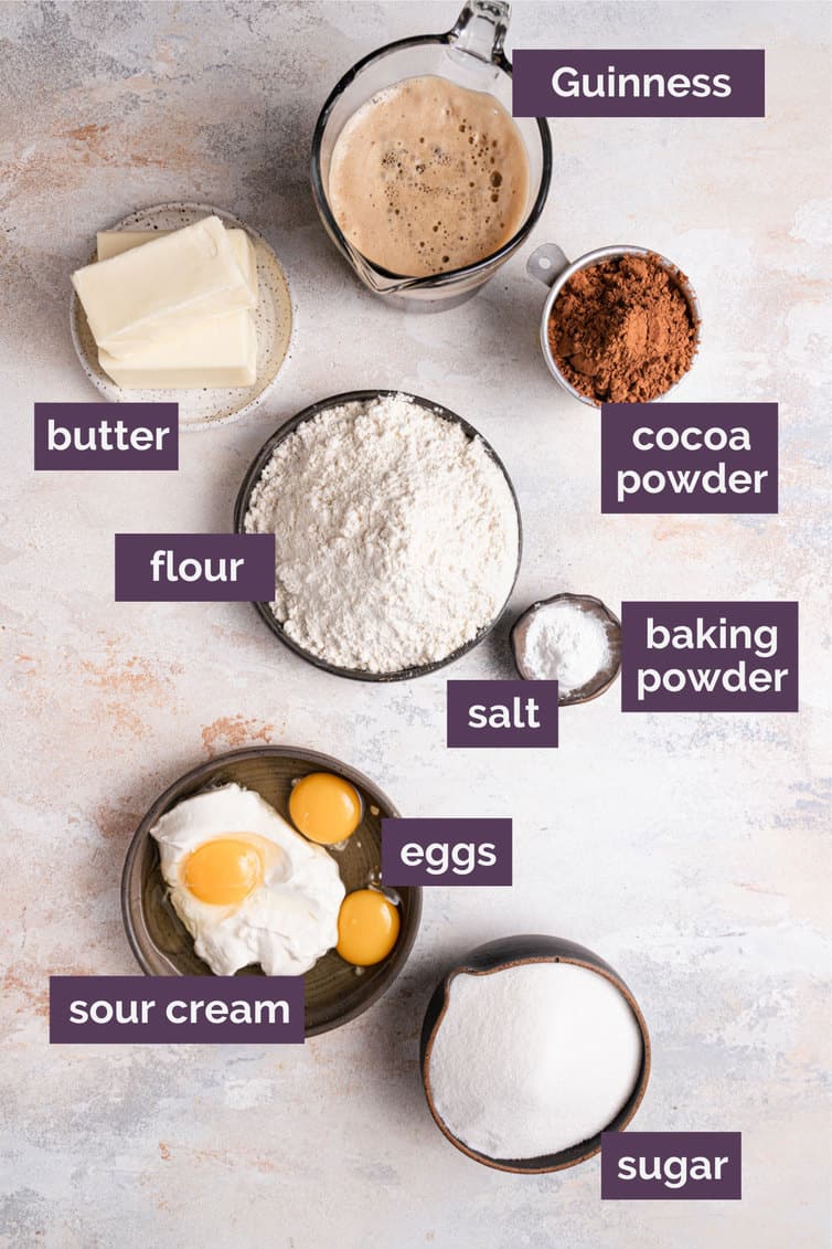 Ingredients for Guinness chocolate cake in bowls on a counter with labels saying what each ingredient is what.