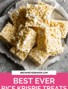 A silver plate lined with parchment paper with a stack of rice krispie treats on top and a pink rectangle at the bottom with the words Best Ever Rice Krispie Treats at the bottom in white.