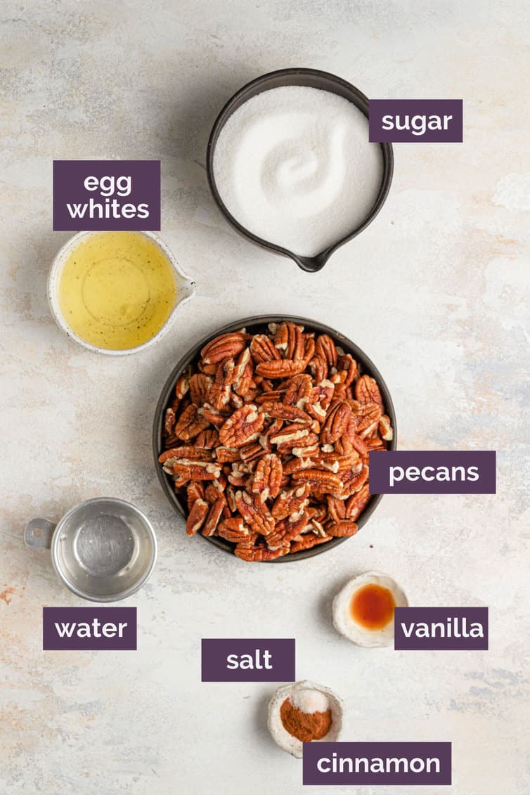 The ingredients for candied pecans on a white counter labeled with purple labels.