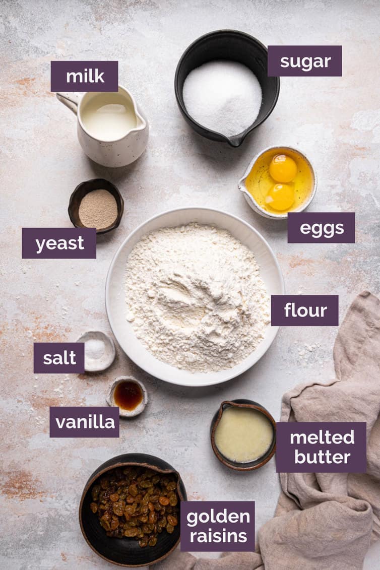 The ingredients for paska bread in bowls on the counter labeled with purple labels.