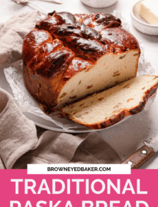 A loaf of paska bread on parchment paper with a slice cut on the right side and a pink rectangle at the bottom that says traditional paska bread.