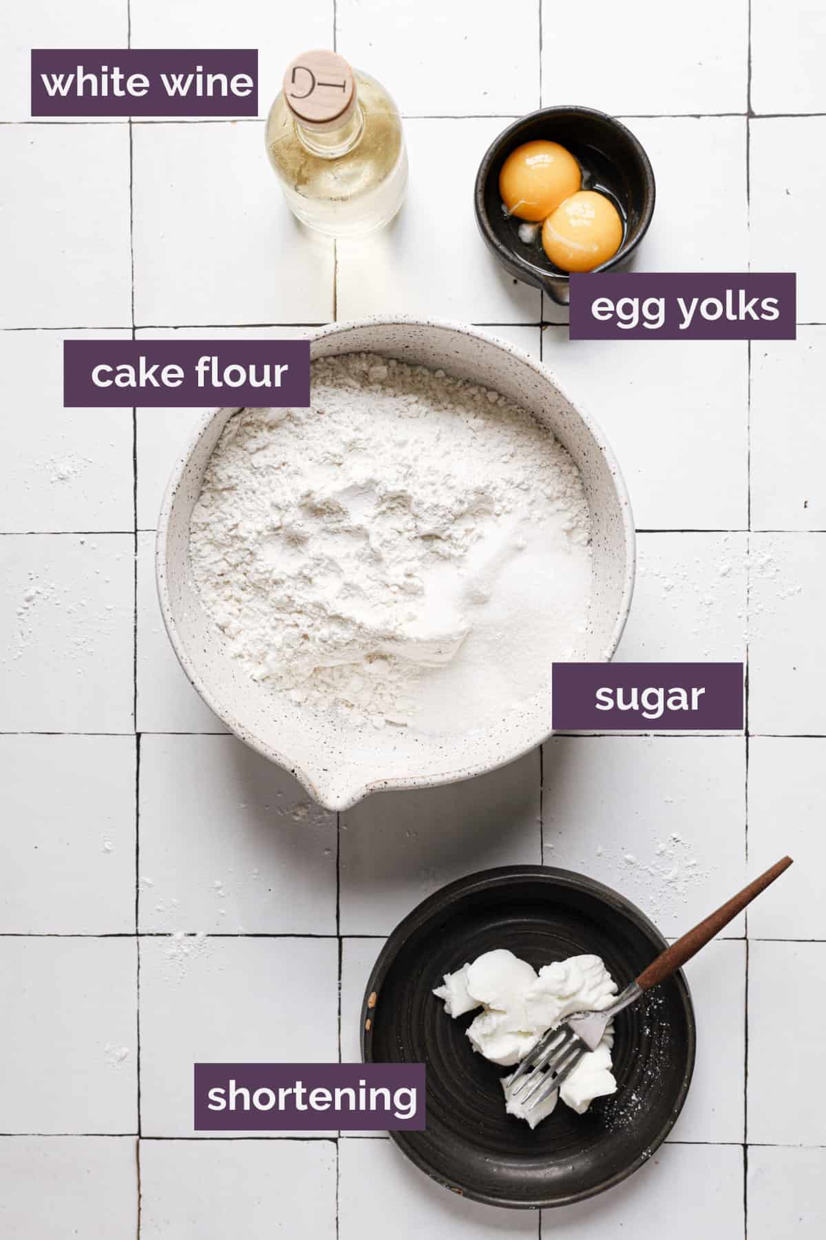 Ingredients for cannoli shells in bowls labeled with purple labels.
