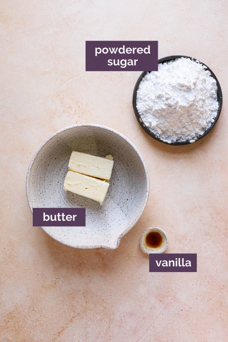 Ingredients for vanilla buttercream frosting in bowls with purple labels.