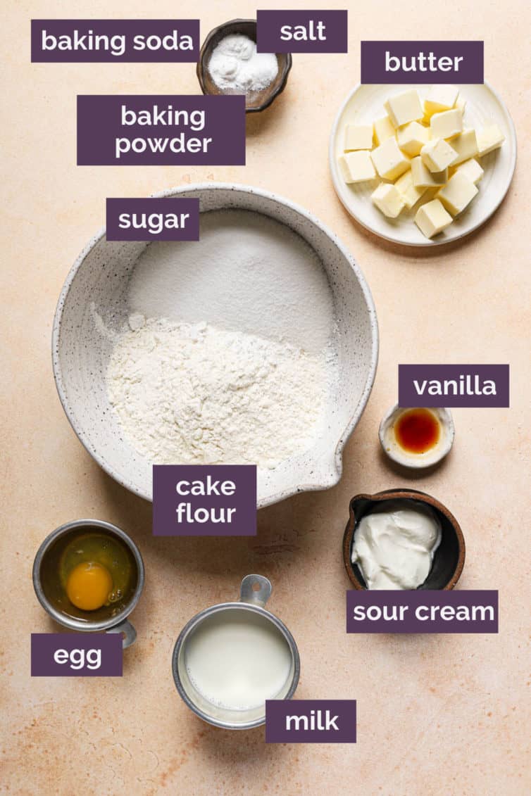 Ingredients for vanilla cupcakes on a counter labeled with purple labels.