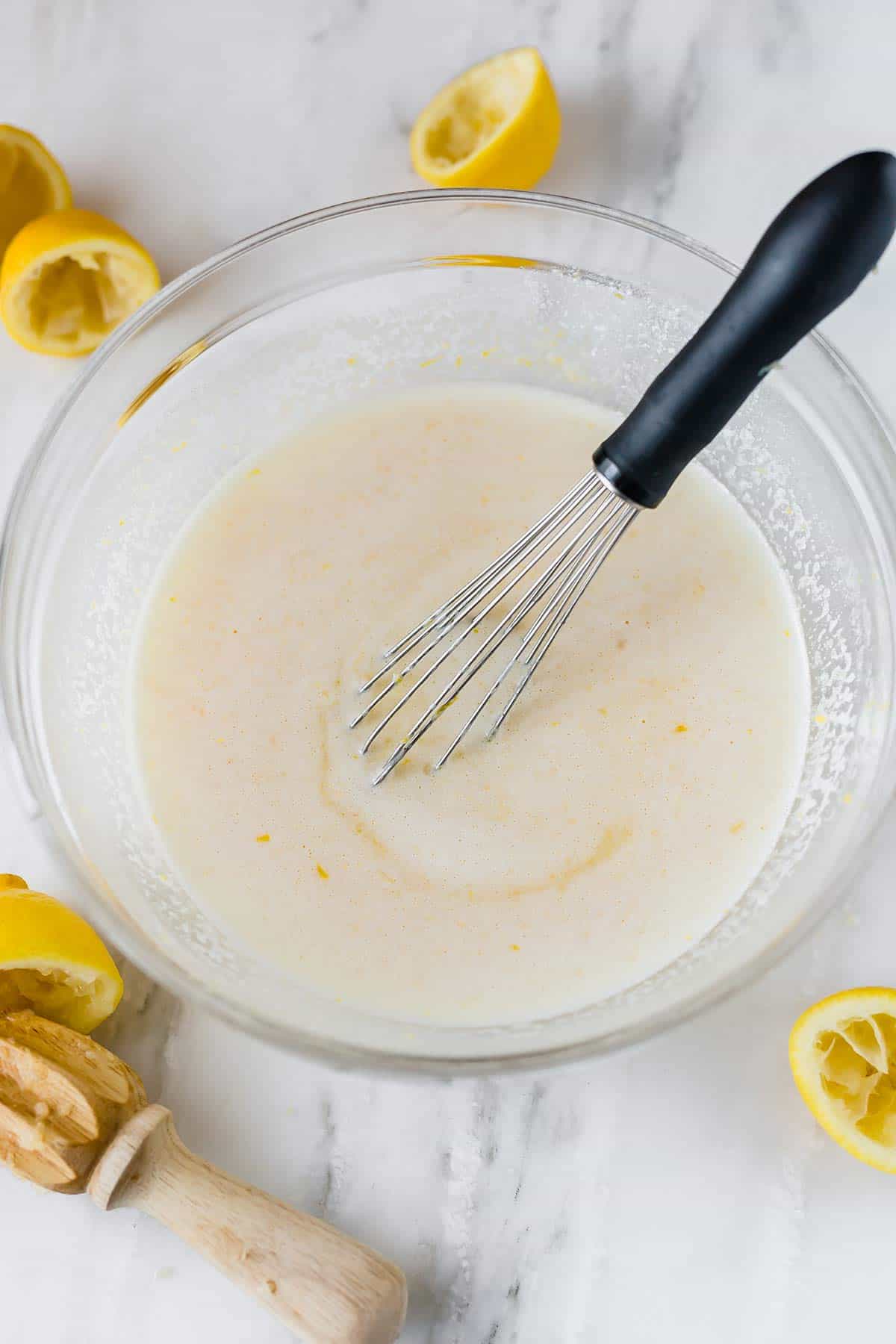 Filling for lemon bars whisked together in a bowl.