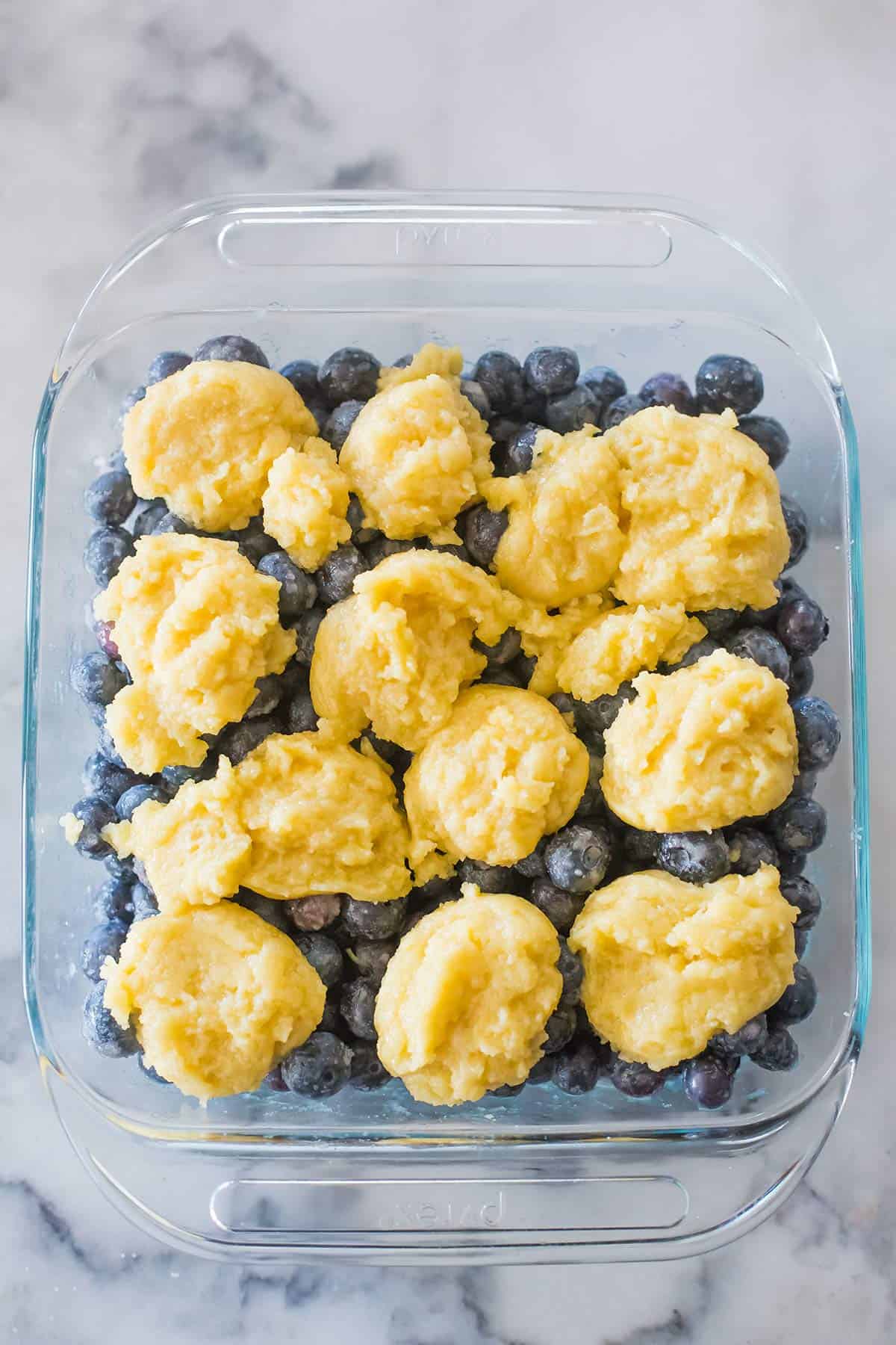 Assembled pan of blueberry cobbler before going into the oven.