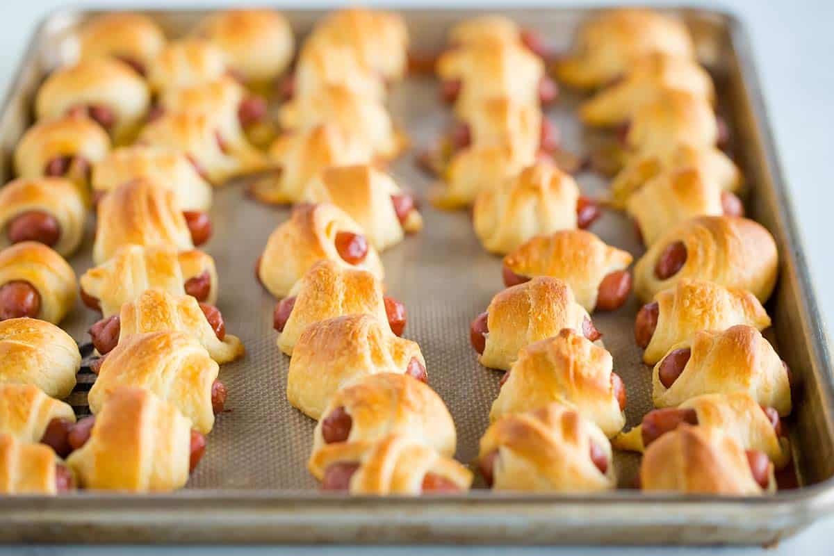 A sheet pan with baked pigs in a blanket.