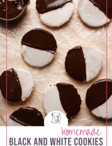 A parchment paper covered counter with black and white cookies with a pink border and the words homemade black and white cookies at the bottom.