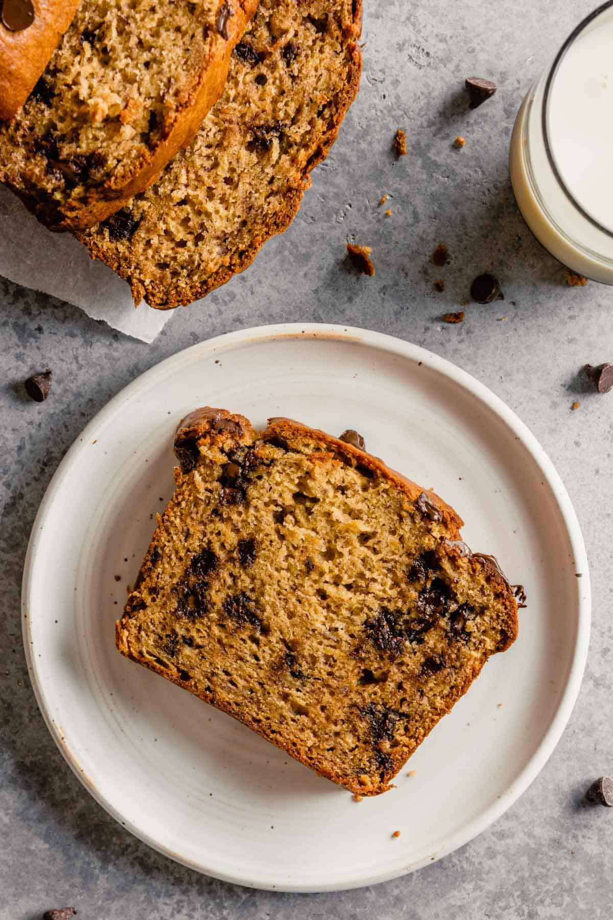 Overhead photo of slice of peanut butter banana bread on a white plate.