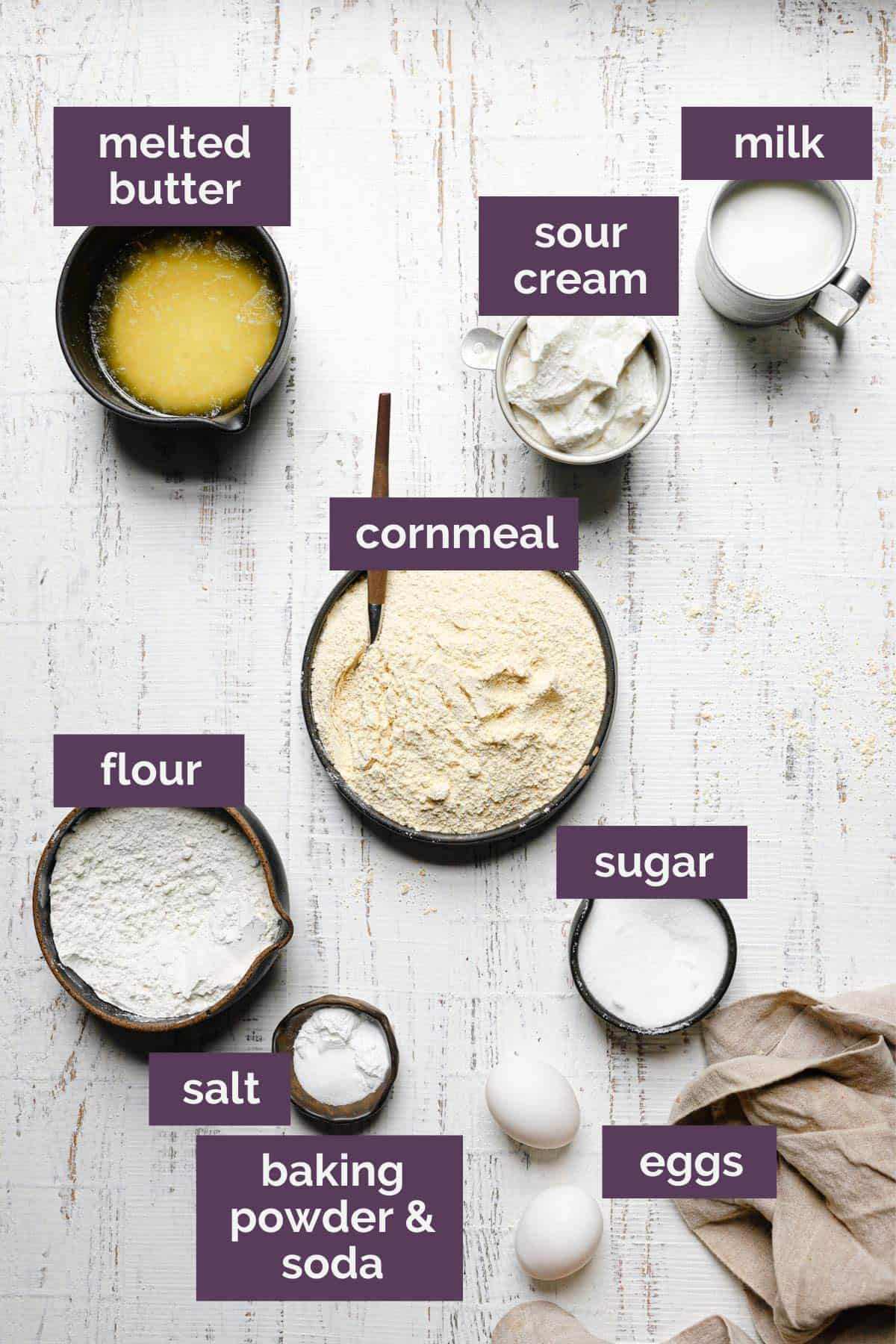 A top down photo of the ingredients for cornbread muffins labeled with purple tags.