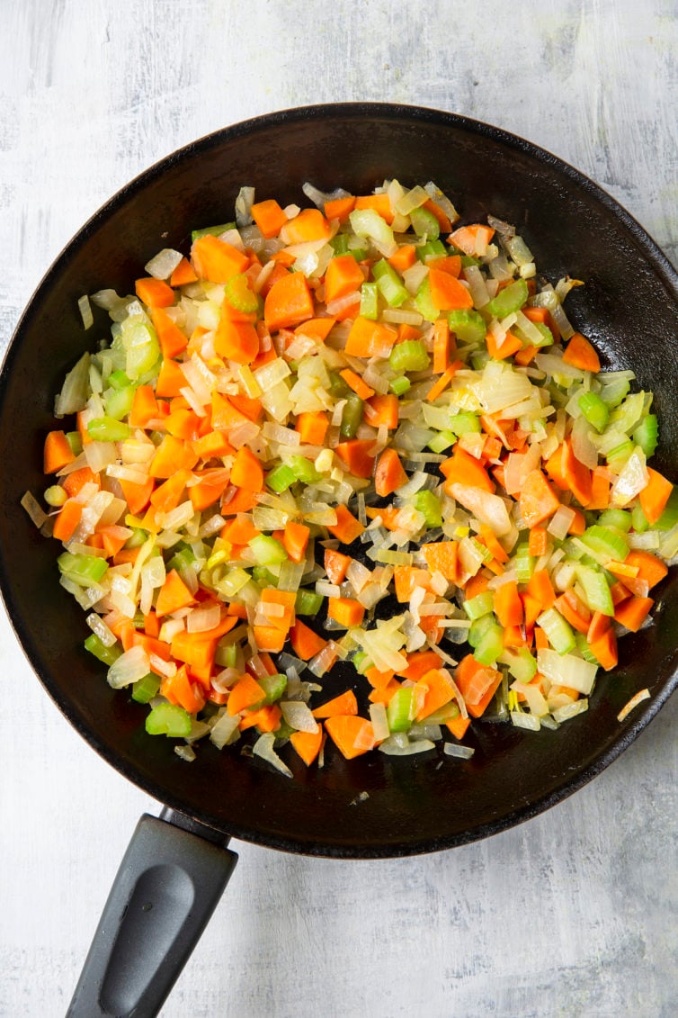 Onions, celery, and carrots in skillet