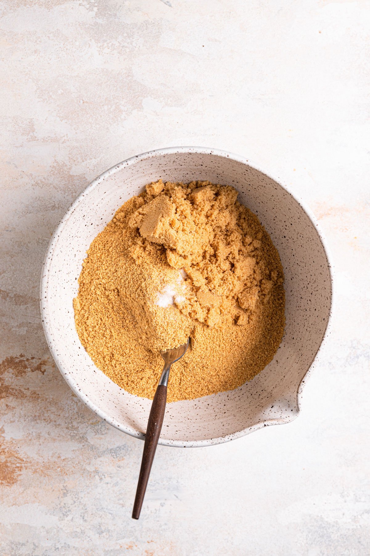 Graham cracker crumbs, brown sugar, and salt in a mixing bowl.