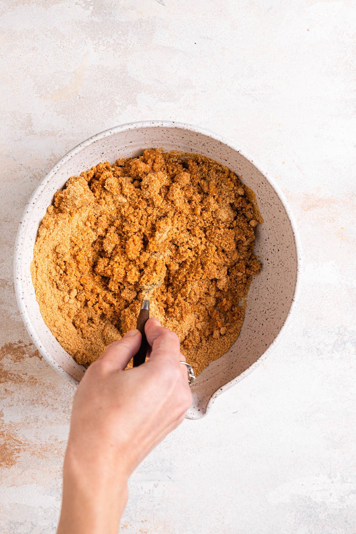 Mixing together graham cracker crust.