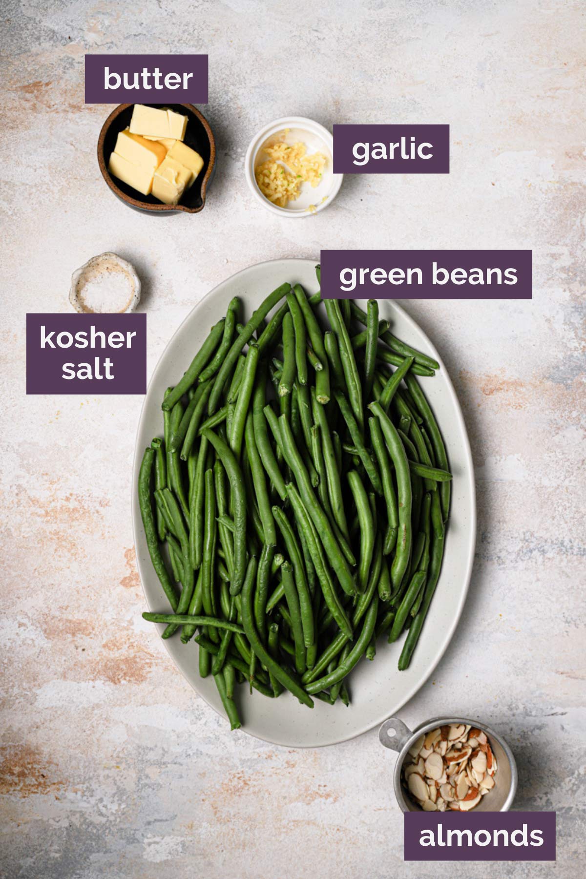 Ingredients for green bean almondine prepped and labeled.