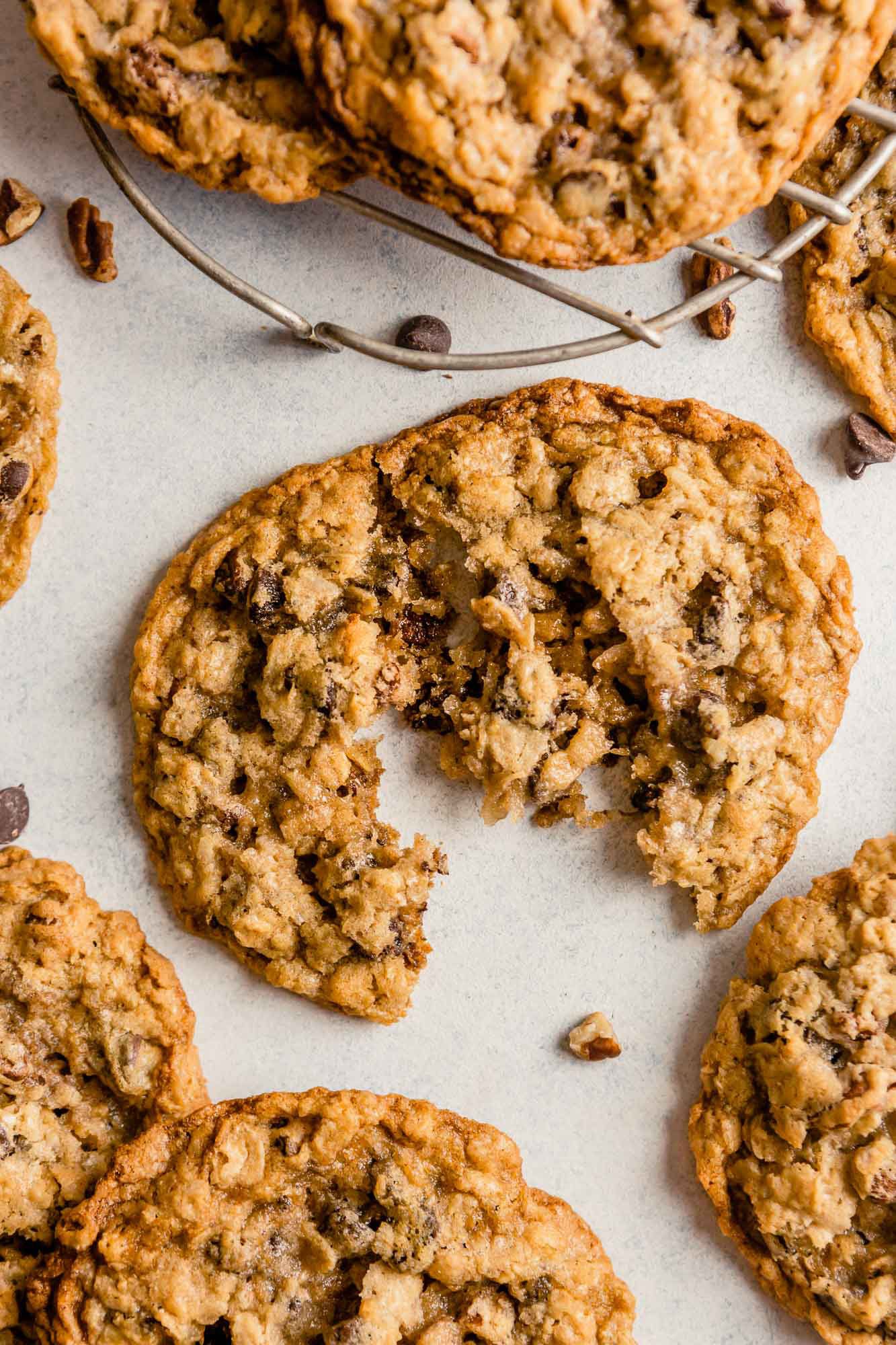 Cowboy cookies surrounding one broken in half.