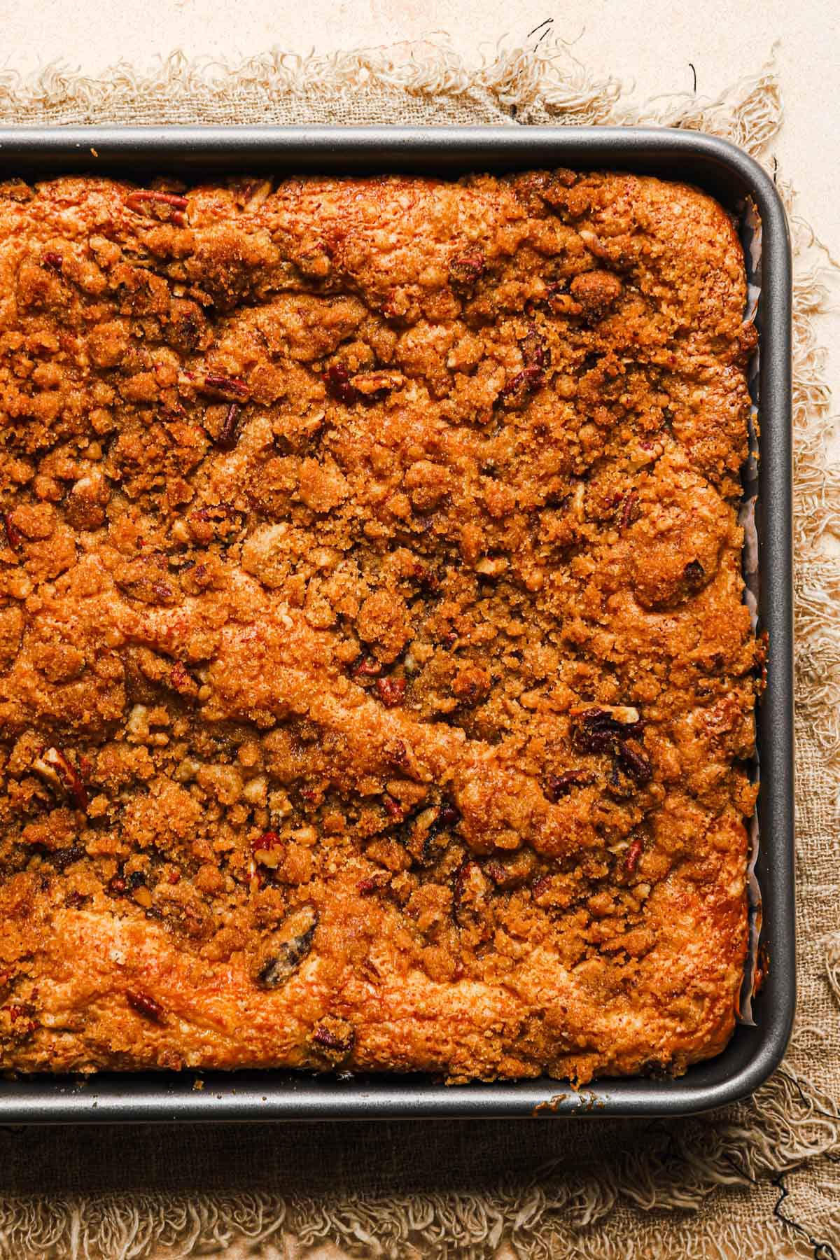 Overhead closeup photo of a coffee cake in a pan.