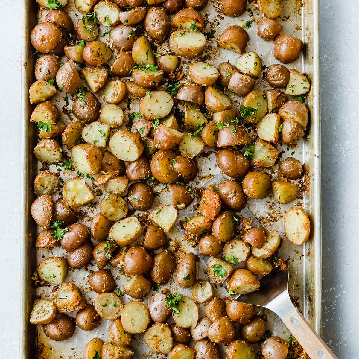 Sheet pan with roasted red potatoes.