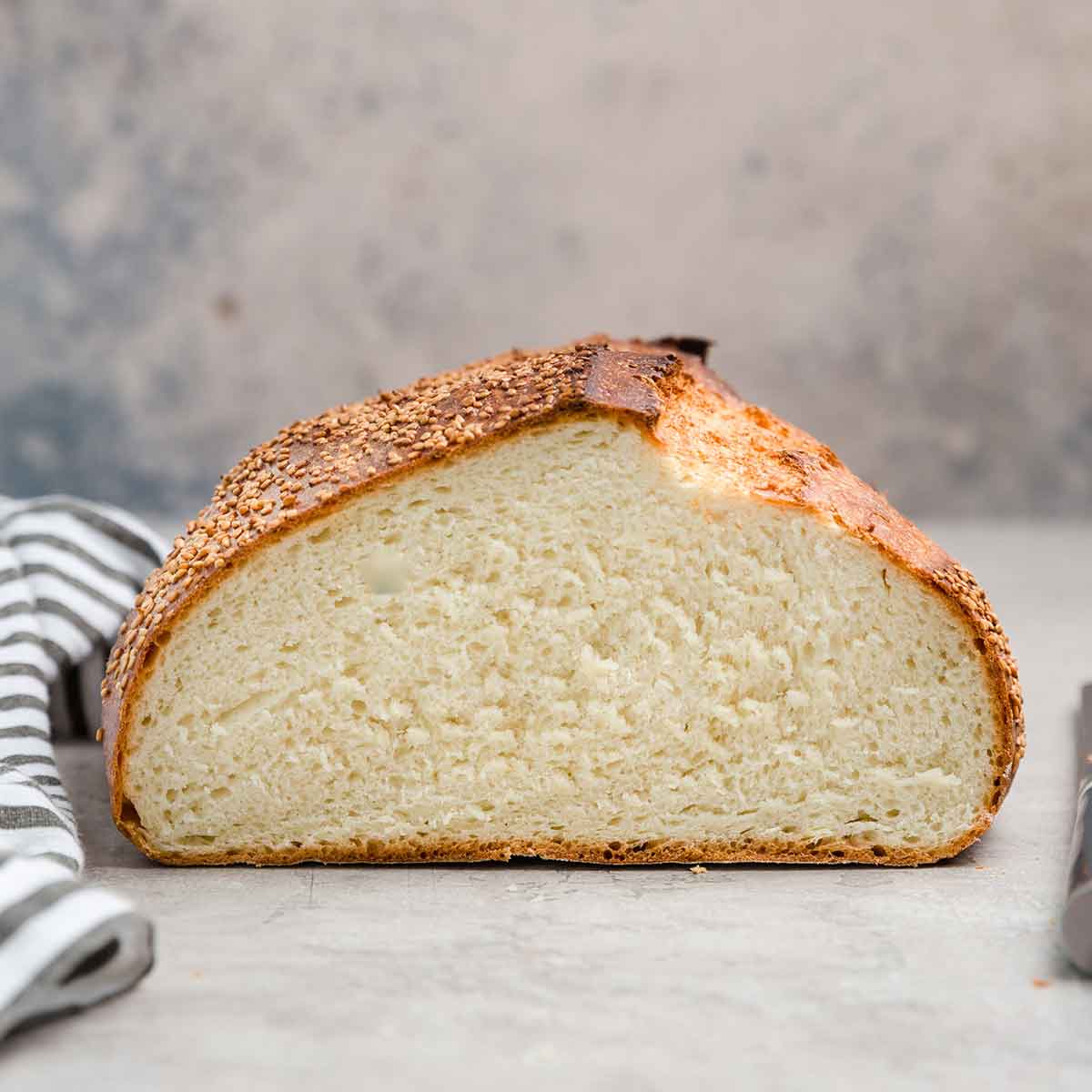 Photo straight on of half a loaf of Italian bread, interior crumb shown.