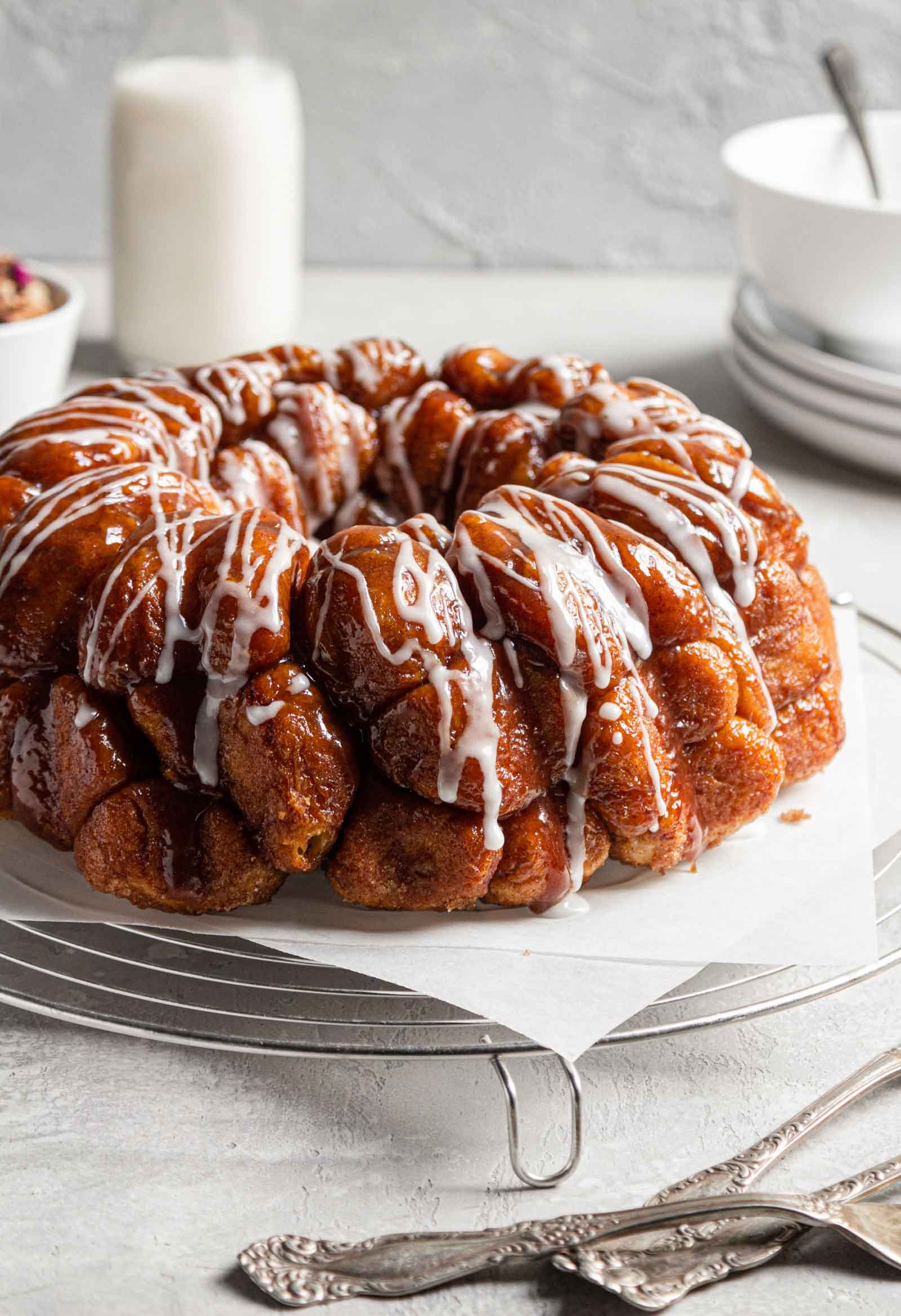 Close up photo of baked monkey bread with a powdered sugar glaze drizzled over top.