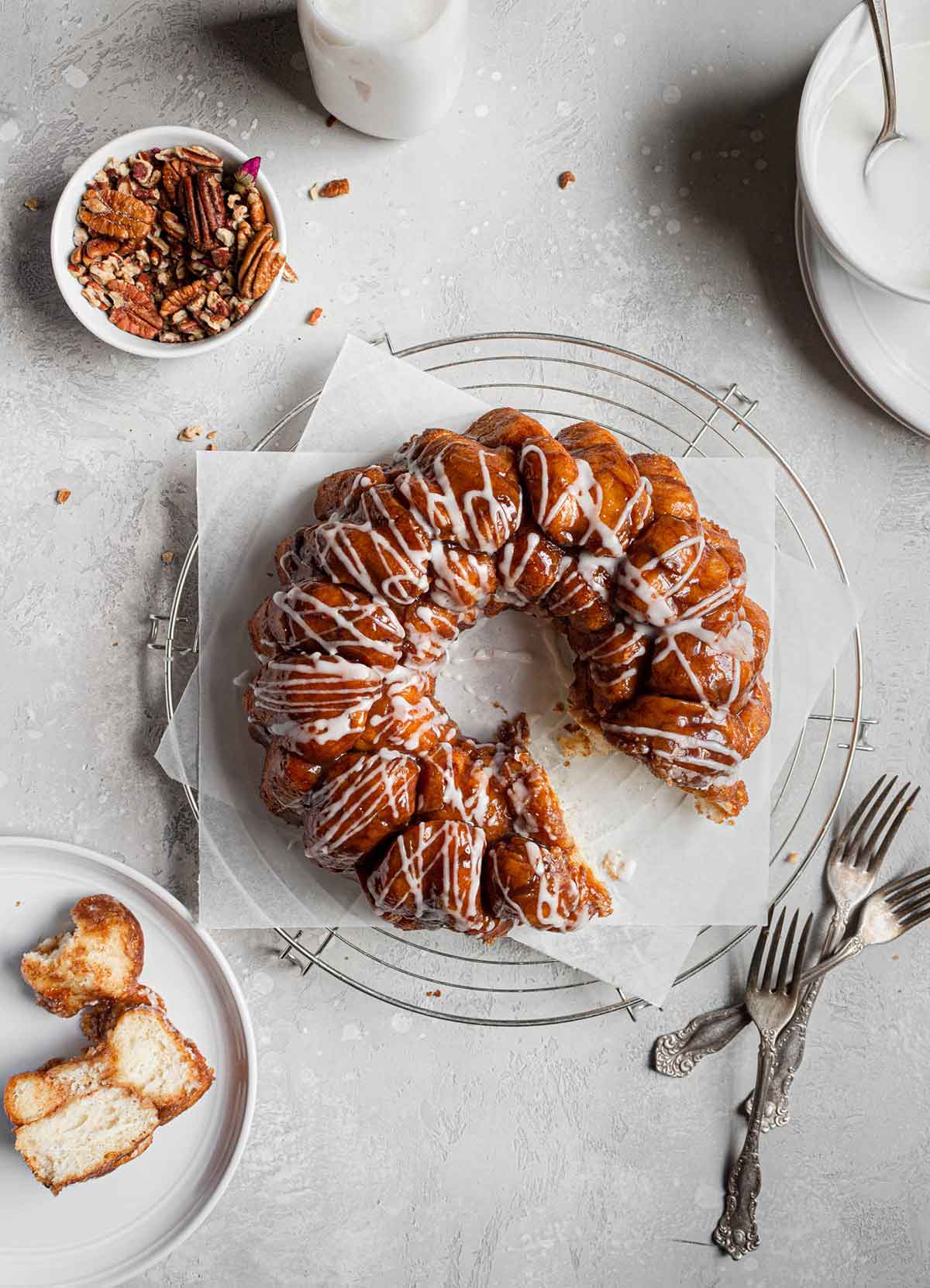 Overhead photo of baked monkey bread with a section taken out and plated to the side.