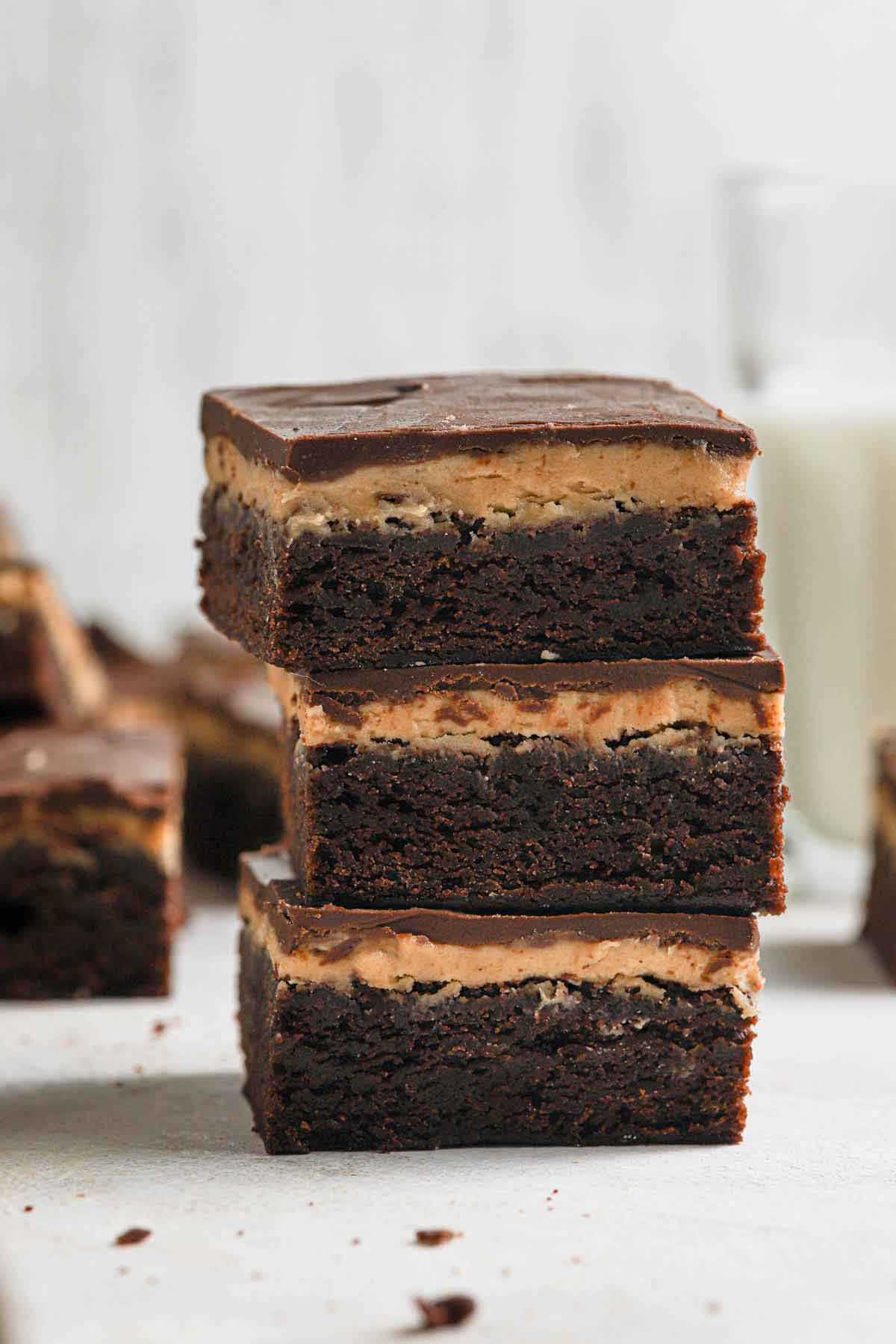 Stack of three buckeye brownies with others in the background.