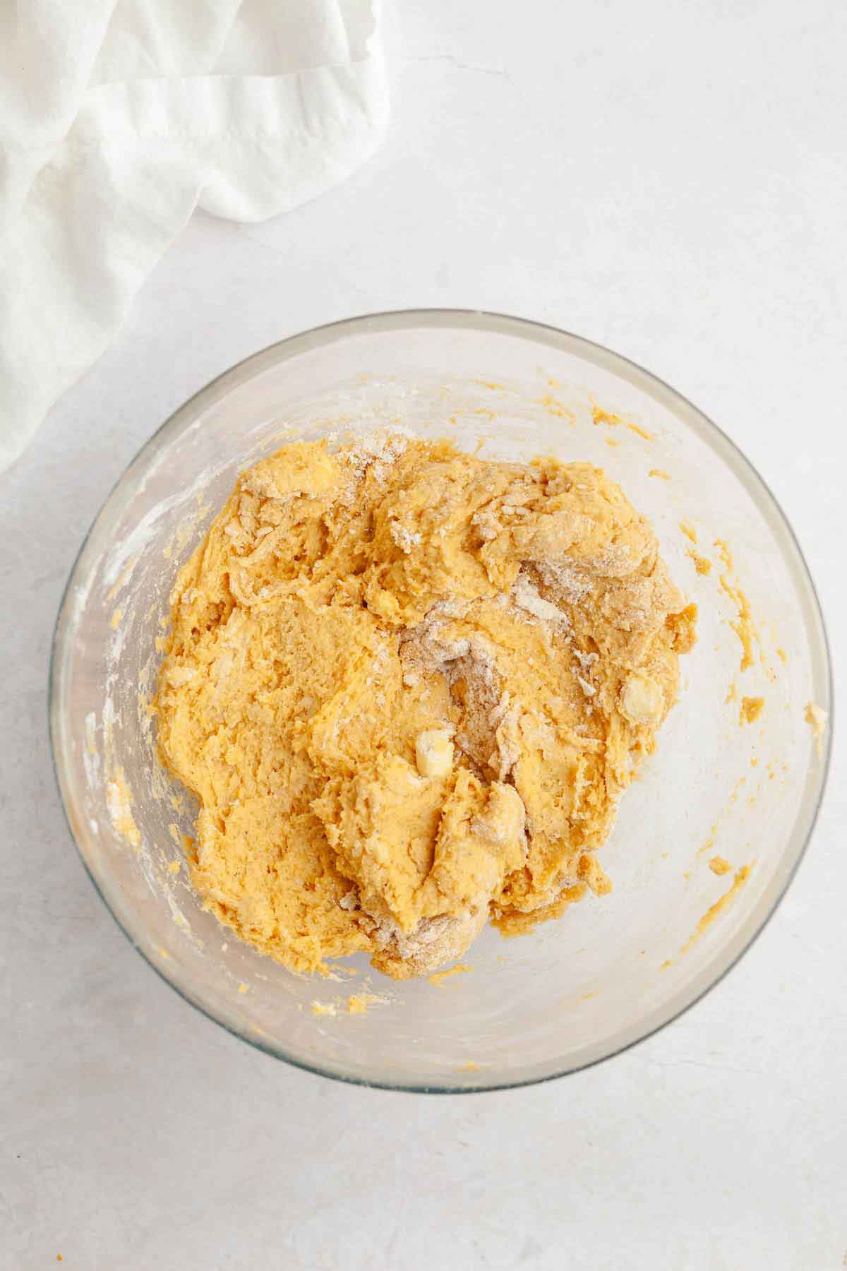 Glass bowl with pumpkin scones dough.