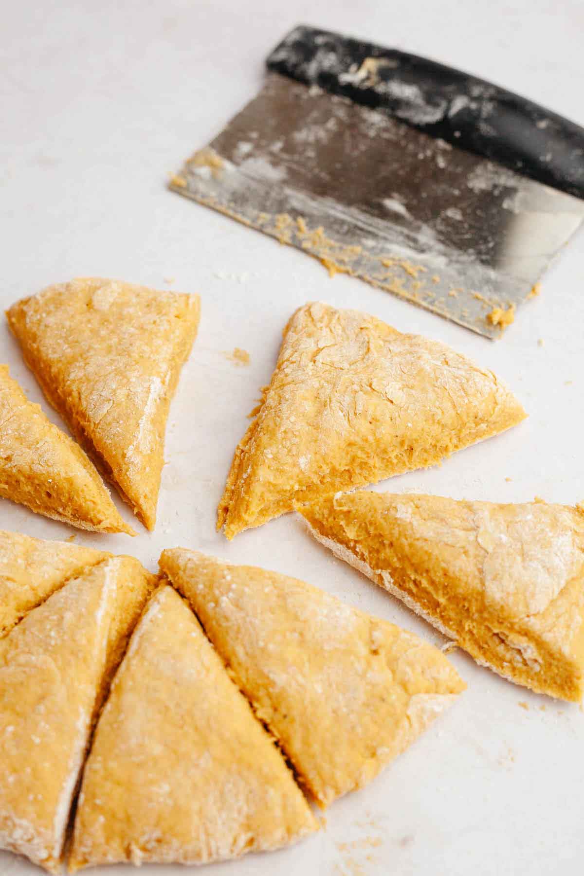 Dough for pumpkin scones cut into triangles. 