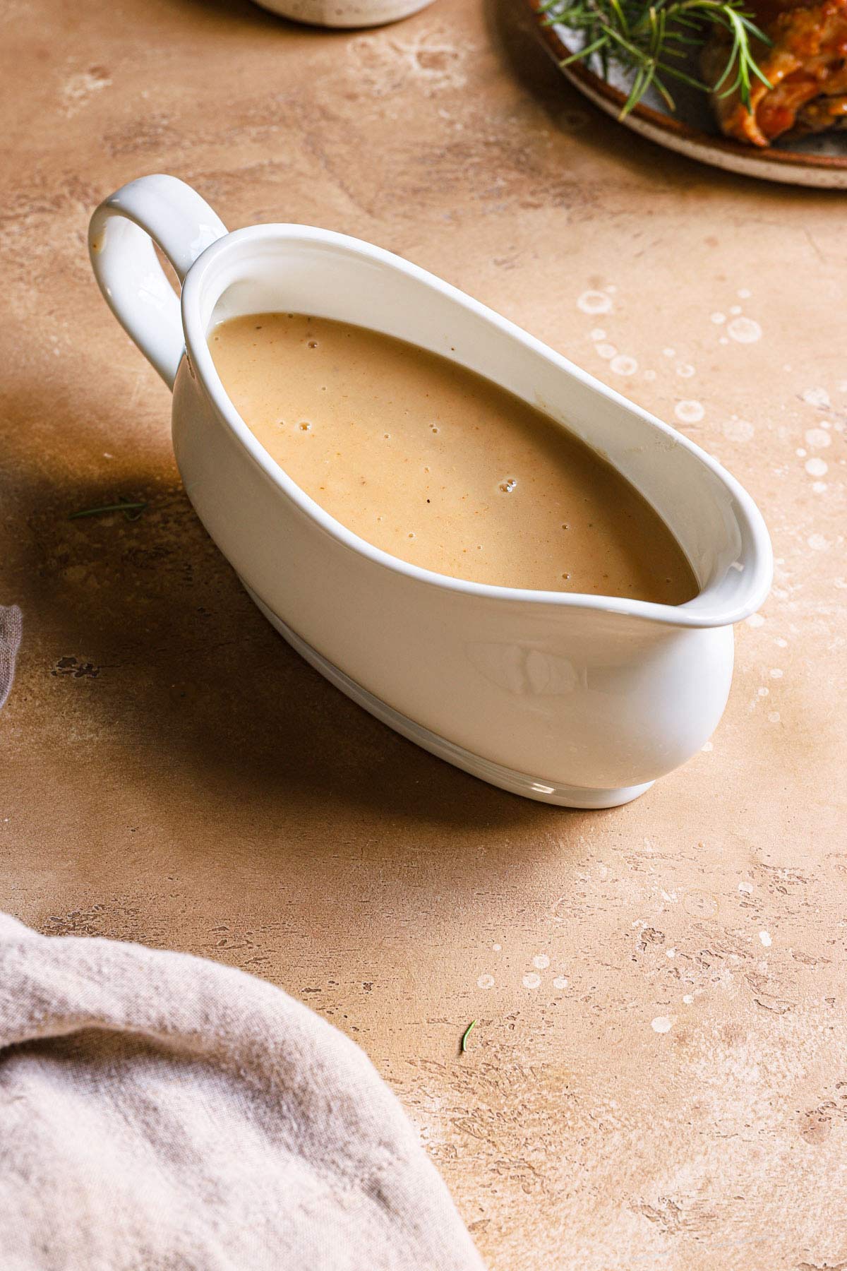 White gravy boat with homemade make ahead turkey gravy.