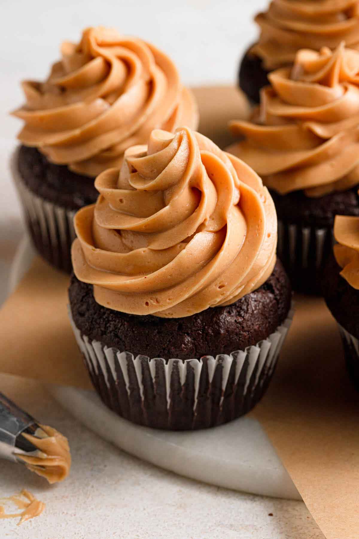 Chocolate cupcakes topped with a swirl of peanut butter frosting.